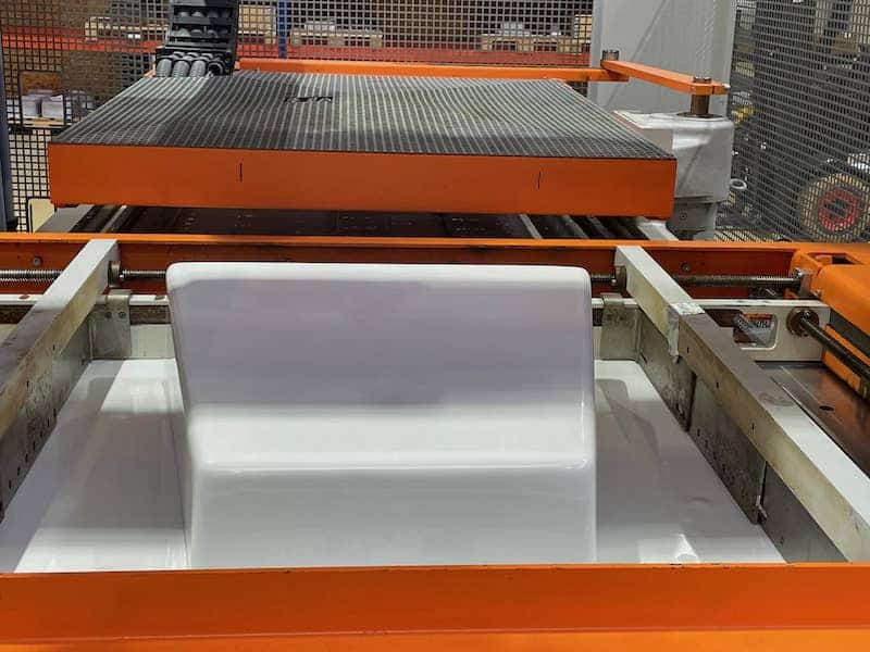 Thermoforming mold in the machine with orange metal parts