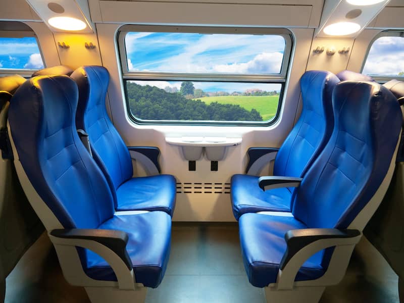 Train seats in blue arranged in a 4rer group